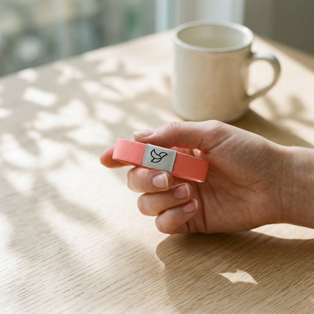 Hand holding the bracelet to show its small, light size